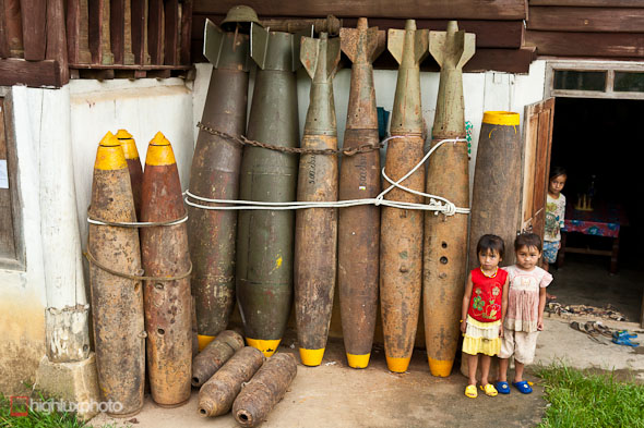Defused UXO outside a house in Xieng Khouang. Over 30% of the bombs dropped on Laos by the US failed to explode - leaving literally millions of items of ordinance (many of them tiny mine bomblets from cluster bombs) sitting in villages, buried in rice padddies, and scattered over the hillsides. Casualties from UXO are estimated at 12,000 since 1973. A substantial industry in scrap metal has arisen from the abundance of recoverable (but still fused) bombs, both due to its relative lucrativeness (compared with growning rice), and also out of desperation, as thousands of hectares of land has been rendered unfarmable until cleared of UXO. Once defused, much of this war scrap is also put to practical use; cluster bomb casings are used as planters and house stilts, bomb cases for fencing and jettisoned fuel tanks converted into fishing boats. Evidence of this resourcefulness is everywhere in the Plain of Jars region.